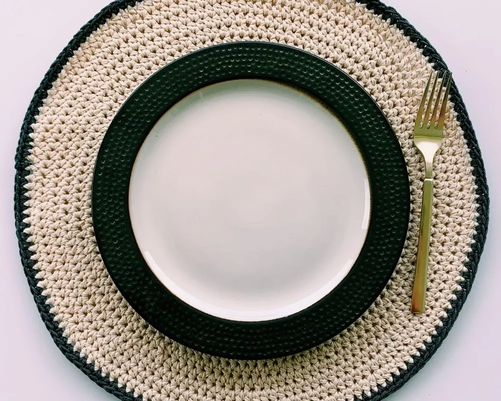 round crochet placemat pattern with decorative plate and fork