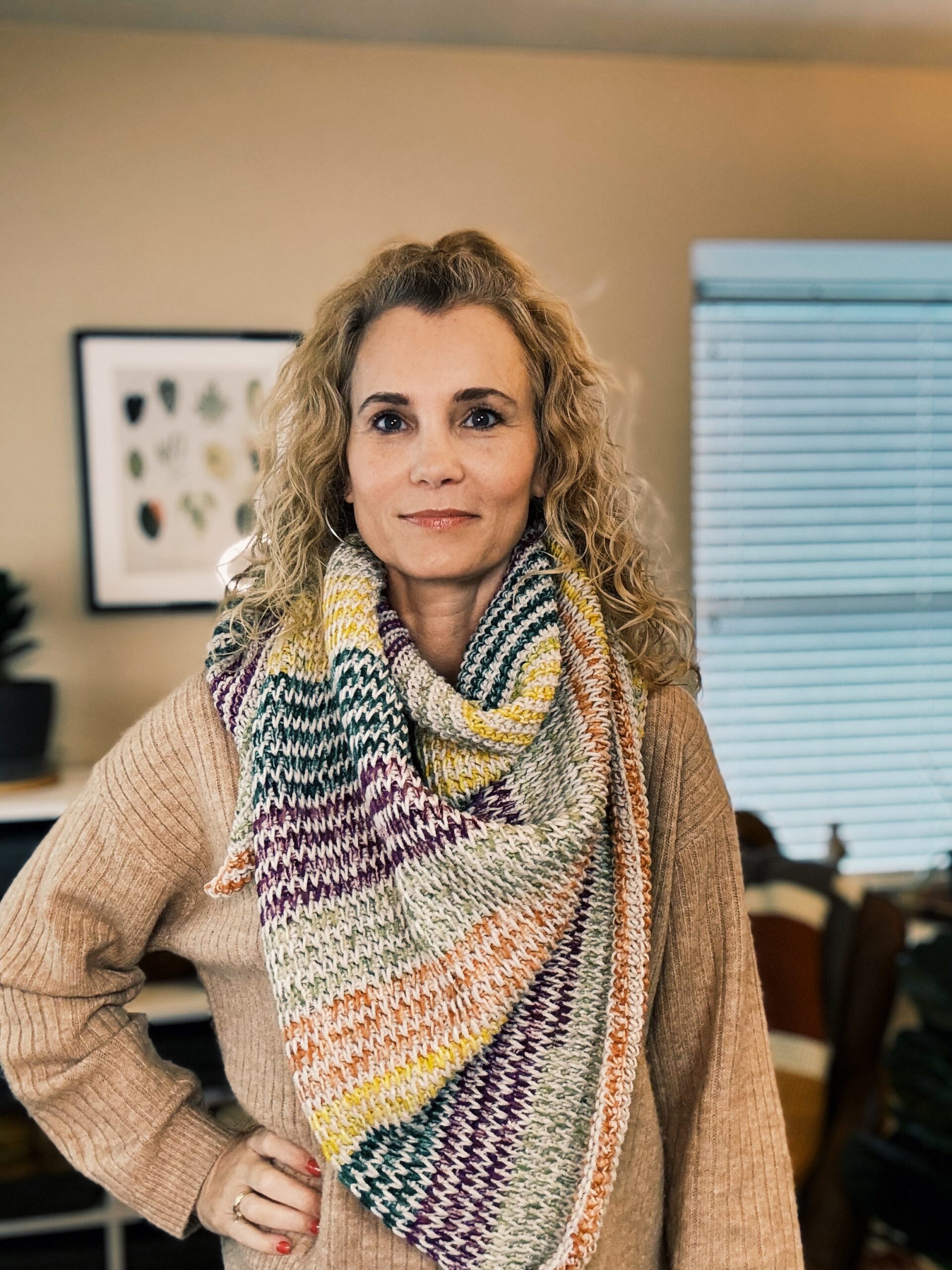 woman with curly hair wearing tunisian crochet triangle scarf
