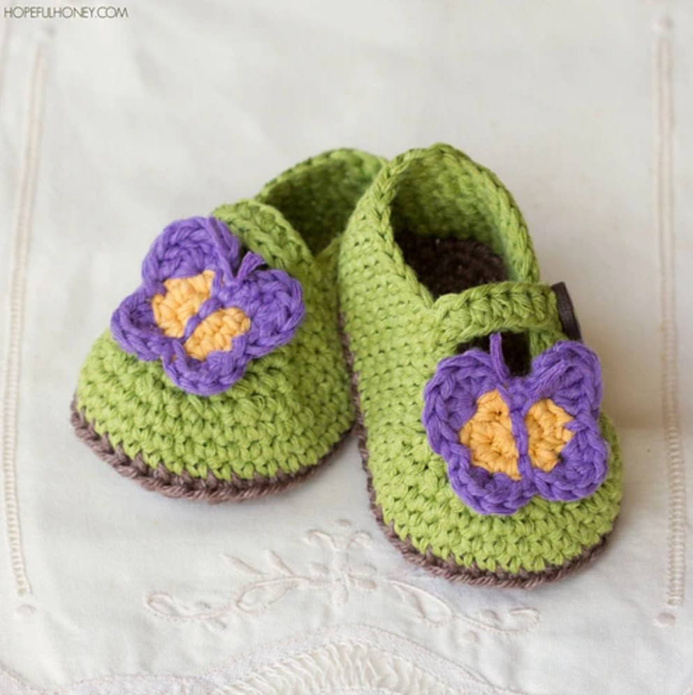 tiny crochet shoes with a butterfly applique
