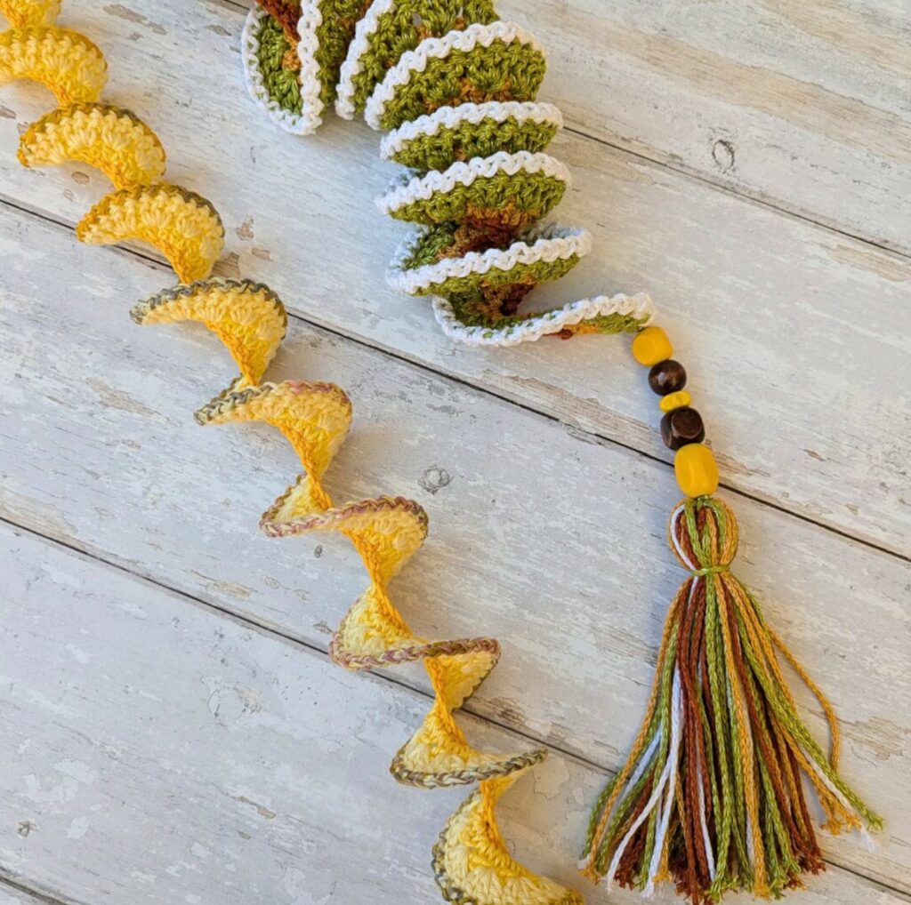 Close-up of a handmade crochet wind spinner with bright colors and spiral shape.