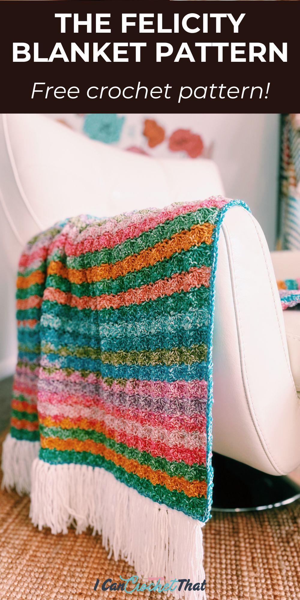 A colorful striped crochet blanket with white fringe is draped over a white chair. Text at the top reads, The Felicity Blanket Pattern - Free crochet pattern!.
