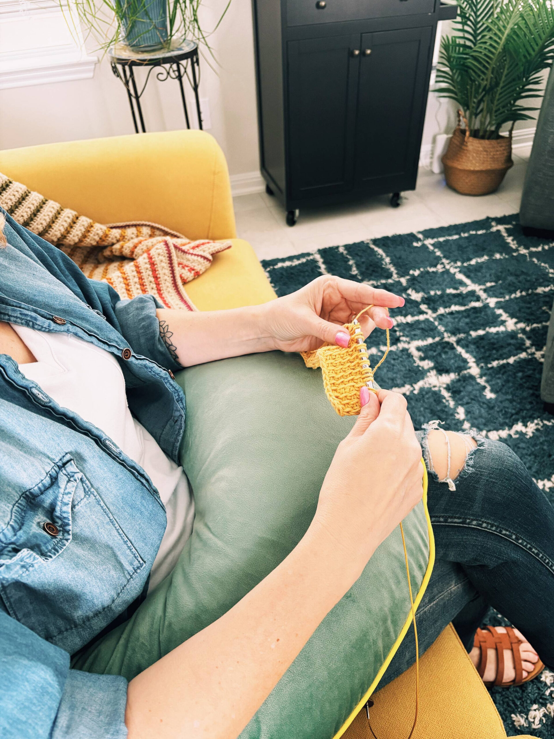 woman using pillow support to help with posture while crocheting