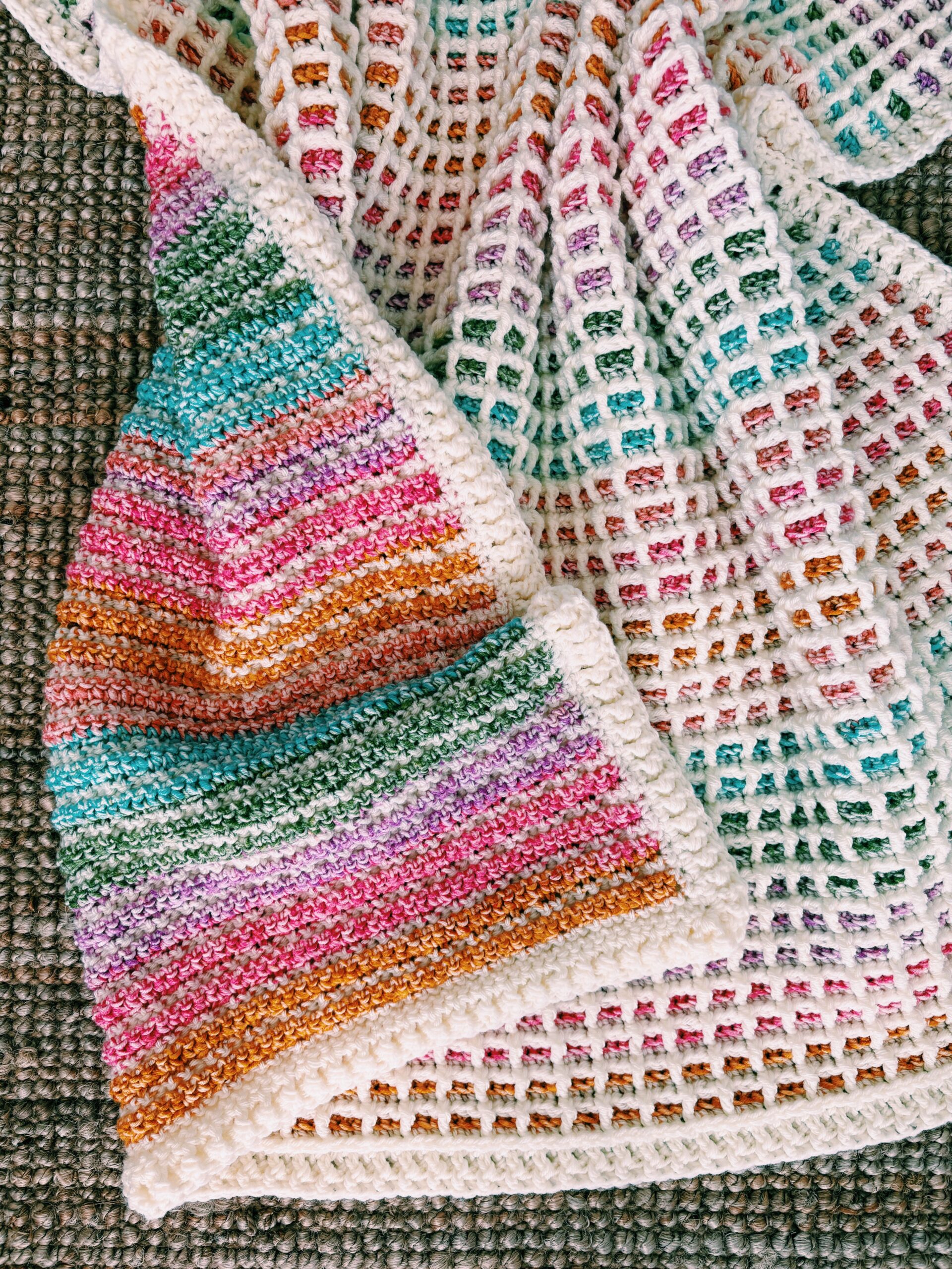 Folded waffle stitch blanket displaying color gradients from self-striping yarn