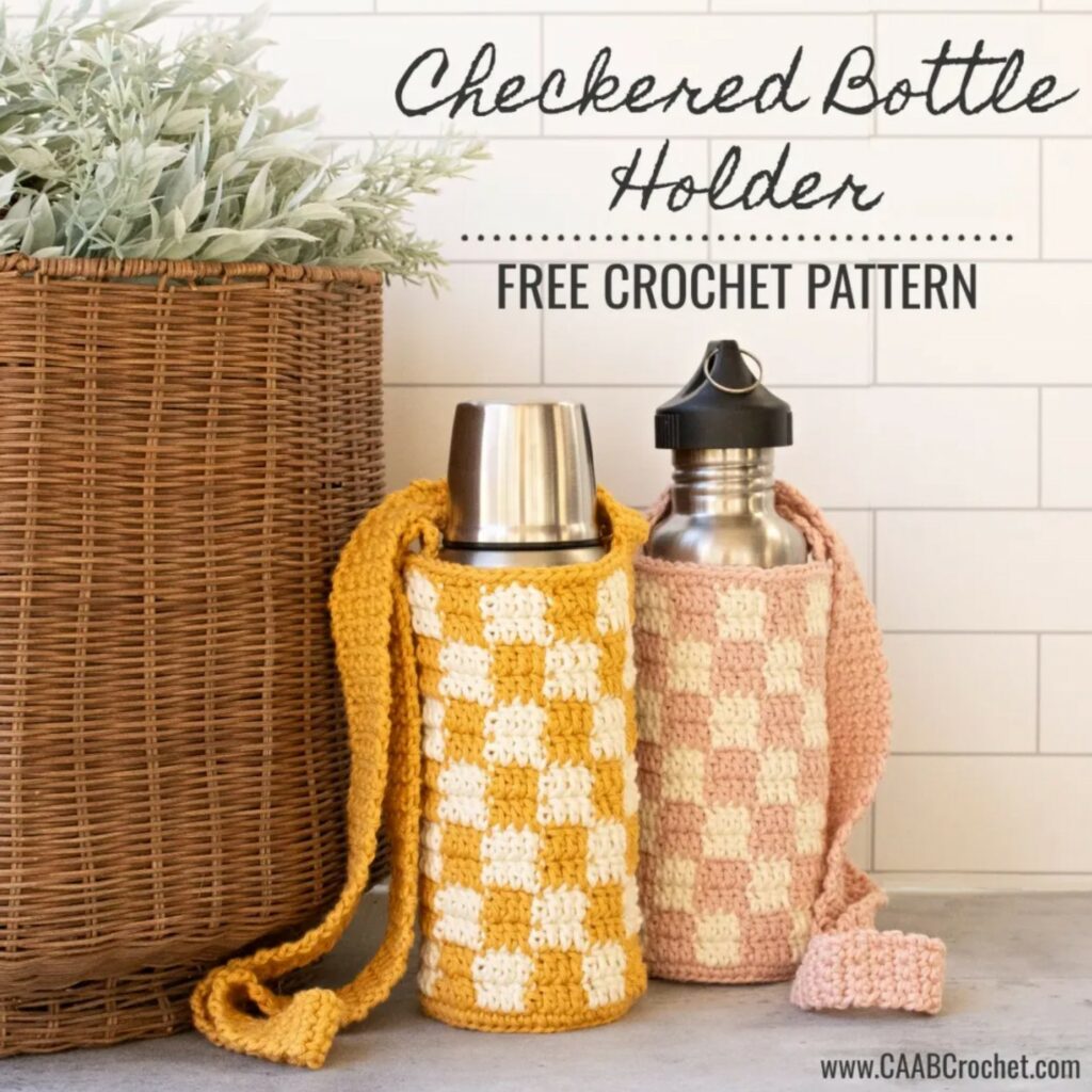 Two crocheted checkered bottle holders with shoulder straps, one yellow and white, one pink and white, displayed next to a woven basket and plants—perfect Back-to-School Crochet or September Cozy crochet project ideas. Checkered Bottle Holder Free Crochet Pattern.