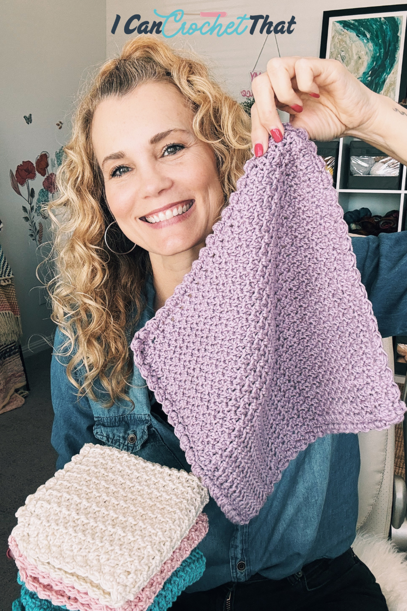 Smiling woman holding up a purple crocheted square, with a stack of folded crocheted squares in various colors in her other hand. The text above reads I Can Crochet That.