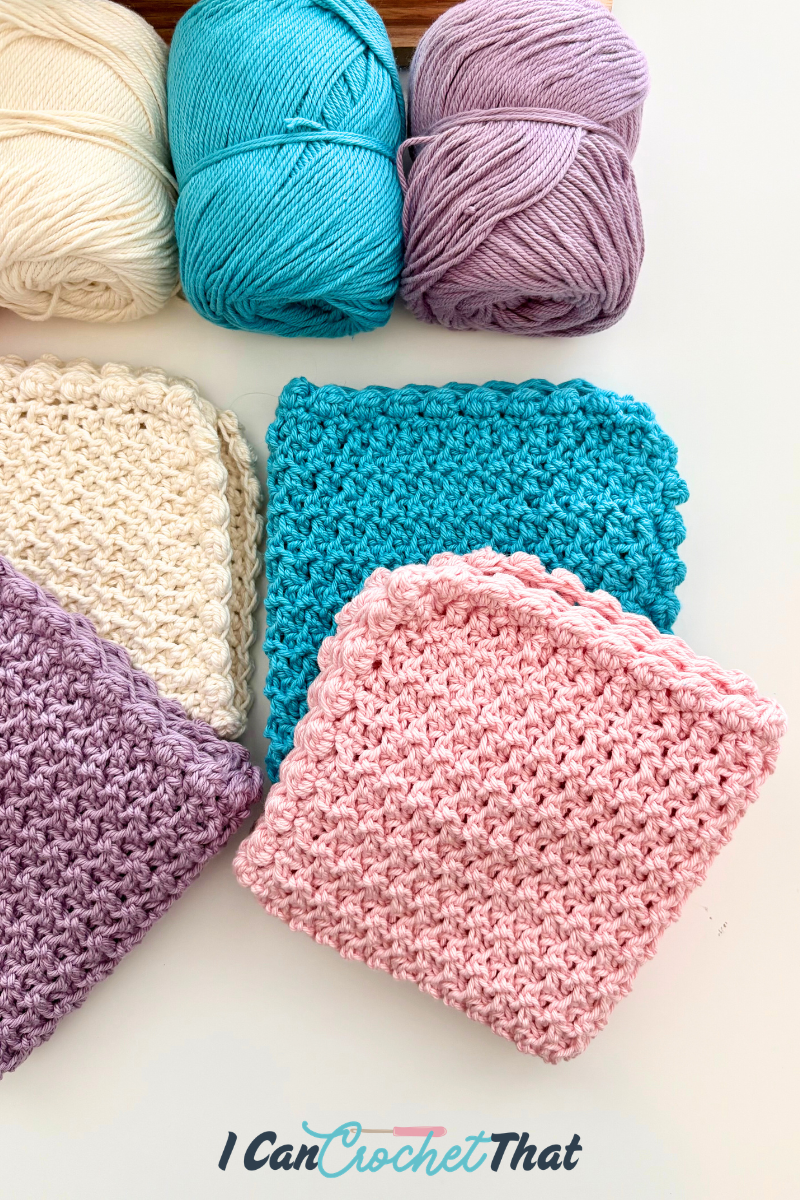 Three skeins of yarn and four crocheted squares in cream, blue, purple, and pink are displayed on a white surface with the text I Can Crochet That at the bottom.